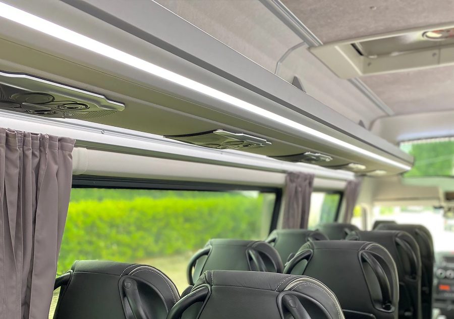 Minibus interior with luggage rack and service units